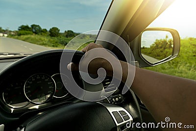 Single hand of man driving car. Stock Photo