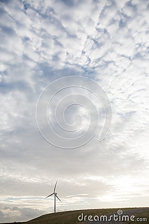 Single alternative energy wind turbine on a hill Stock Photo
