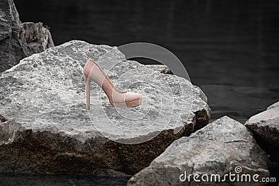 A single high heel on a rock Stock Photo
