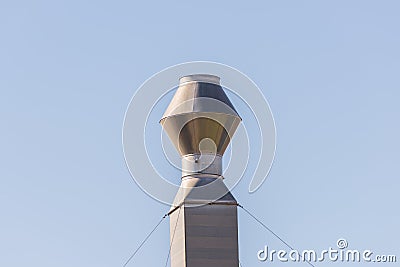 Single industrial chimney, metal smokestack against clear sky Stock Photo