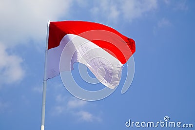 The single large red and white Indonesian flag flutters in the strong wind ahead of the 77th Independence Day. Stock Photo