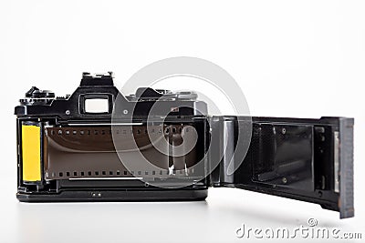 Single lens reflex camera and a film roll on white background Stock Photo