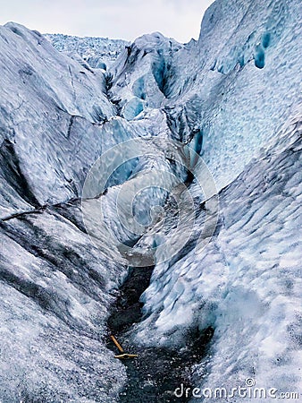 Blue Ice with Ice Pick at the Vatnajökull Glacier in Iceland Stock Photo