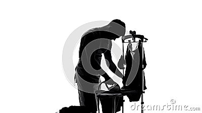 Single man ironing t-shirt for first time, household duties, bachelor lifestyle Stock Photo