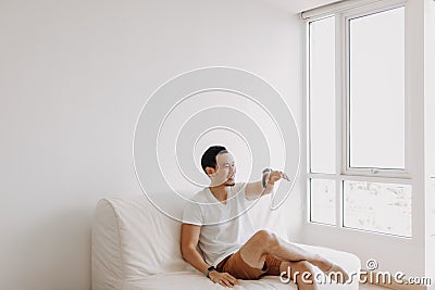 Single man playing with his sugarglider pet alone in his apartment. Stock Photo