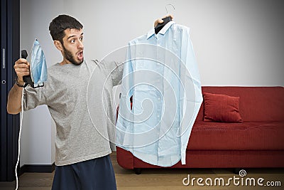 Single man scared about ironing Stock Photo