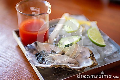 Single oyster with cocktail sauce Stock Photo