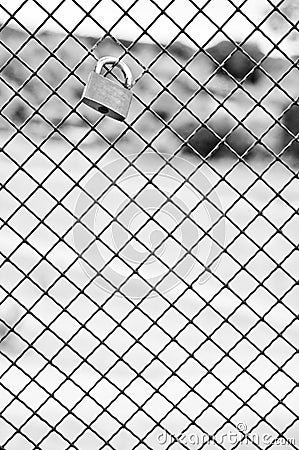 Single padlock attached to a metal fence Stock Photo