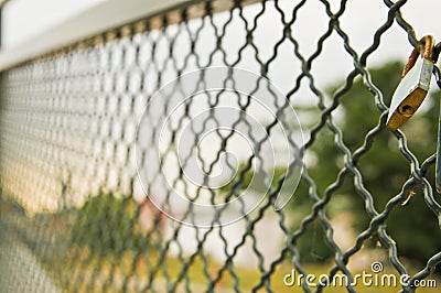 Single padlock attached to a metal fence Stock Photo