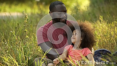 Single parent father taking care of treasured little daughter with curly hair Stock Photo