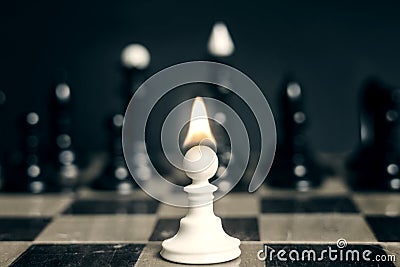 Single pawn with flame tongue on head against many enemies Stock Photo