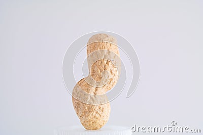 Single peanut in shell macro close up shot vertical curved isolated against with background Stock Photo