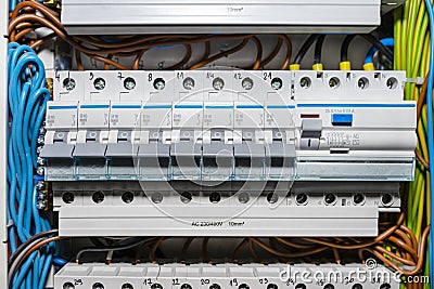 Single phase fuses in OFF position and residual current protection in ON position. Many gray switches in a row, home fuse box. Stock Photo