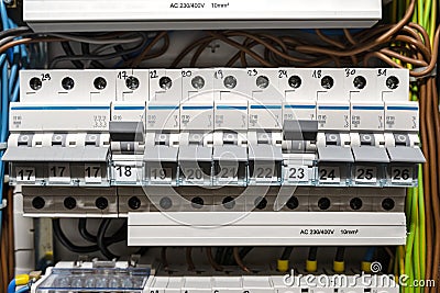 Single-phase fuses in the OFF and ON position and three-phase fuses in the OFF position, placed in the home fuse box, visible elec Stock Photo