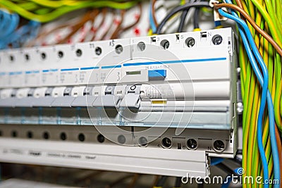 Single phase fuses and residual current protection in OFF position. Many gray switches in a row, home fuse box. Stock Photo