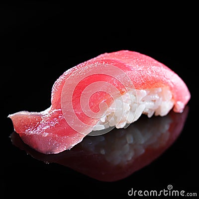 Single piece of tuna sushi nigiri on black background Stock Photo