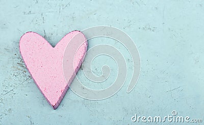 Single pink heart on light blue wooden background Stock Photo