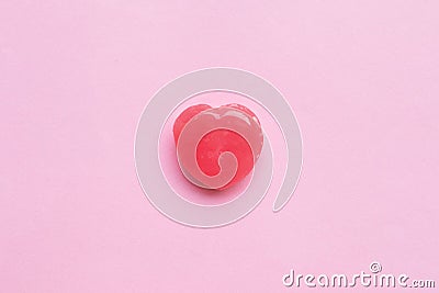Single Pink Valentine`s day heart shape candy on empty pastel pink paper background. Love Concept. top view. Minimalism colorful Stock Photo
