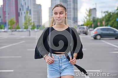 Single portrait of beautiful smiling teenage girl looking to the side Stock Photo