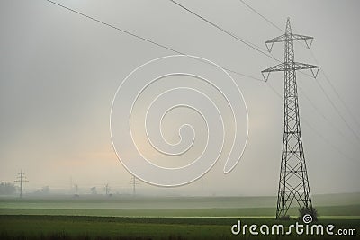 single power pole with dense fog over the fields Stock Photo
