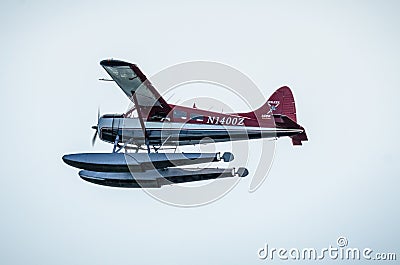 Single Prop Airplane Pontoon Plane flying in alaska mountains Editorial Stock Photo