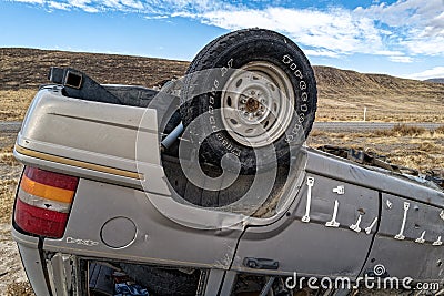 A single rear tire remains attached to a Jeep SUV that rolled over in the desert near Zenobia, Nevada, USA - November 1, 2022 Editorial Stock Photo