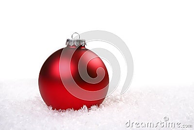 Single Red Shiny Christmas Ornament in the Snow Stock Photo