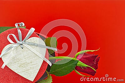 Single rose on gift box and heart medallion Stock Photo