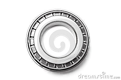 Single row tapered roller bearing made of shiny metal is designed to absorb radial and one-sided axial loads of a vehicle. Spare Stock Photo