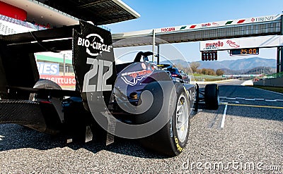 Single seater race car in pole position starting grid rear view on asphalt track Editorial Stock Photo