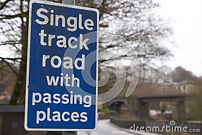 Single track road sign just before a very narrow road Stock Photo