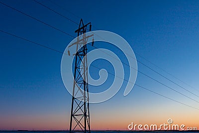 SIngle Transmission Tower against Prairie Sunset Stock Photo