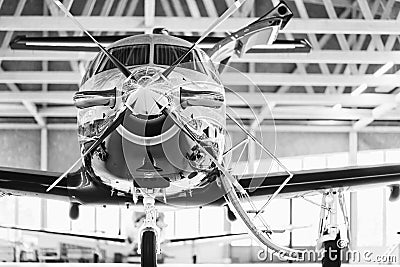 Single turboprop aircraft PC-12 in hangar. Stock Photo