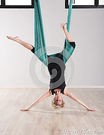 Single upside down woman doing aerial yoga Stock Photo