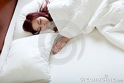Single woman in big bed Stock Photo