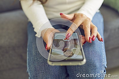 Single woman looking for boyfriend and giving like to man`s profile photo on dating app Stock Photo