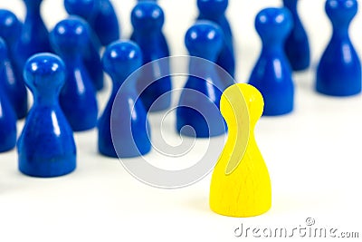 Single yellow halma cone against blue halma cones Stock Photo