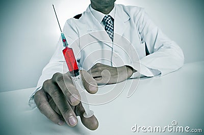 Sinister doctor with a syringe Stock Photo