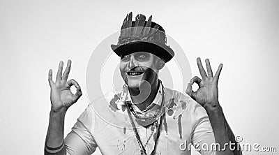Sinister man with horrible Halloween skeleton makeupmaking faces, looking at camera, showing ok sign Stock Photo