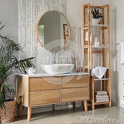 Sink bowl on chest of drawers, mirror and shelving unit in bathroom Stock Photo