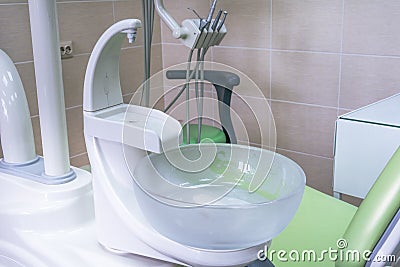 Sink at a dental office. Tools in a dentists office close up background and the chair. Medical equipment and stomatology concept. Stock Photo