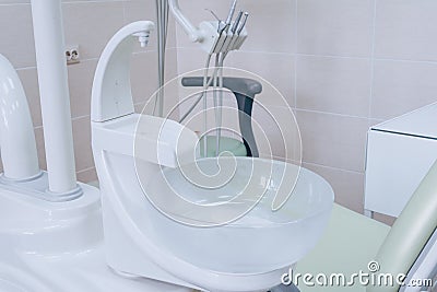 Sink at a dental office. Tools in a dentists office close up background and the chair. Medical equipment and stomatology concept. Stock Photo