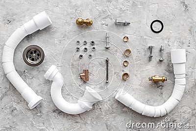 Sink drain parts and plumbing tools on grey stone background top view Stock Photo