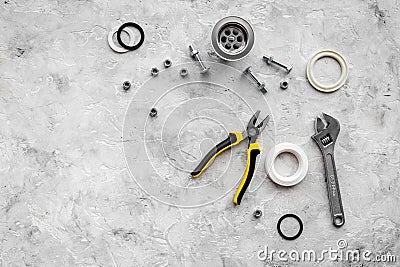 Sink drain parts and plumbing tools on grey stone background top view copyspace Stock Photo