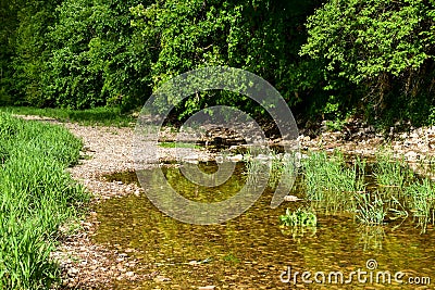 The sinking Danube water disappears into a karst water system of the well-stratified limestone formation. Stock Photo