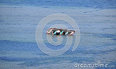 Sinking ship. 2 people trying to get on a sinking ship Stock Photo