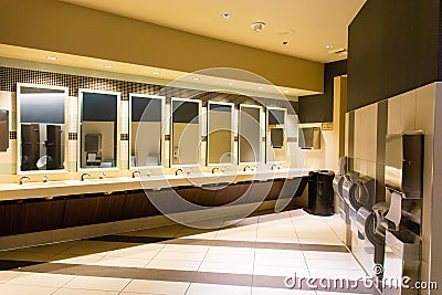 Sinks and hand dryers in public restroom. Stock Photo