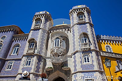 Couple of tourists visiting the Pena Palace a Romanticist castle located in Sao Pedro de Editorial Stock Photo