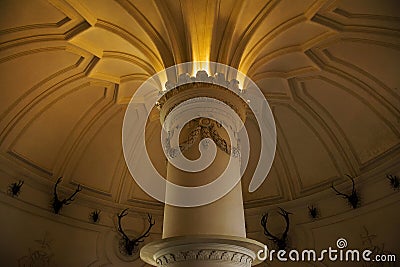 Inside of Pena Palace in Sintra, Lisbon district, Portugal. Close up of a corinthian capital and decorated ceiling. Editorial Stock Photo