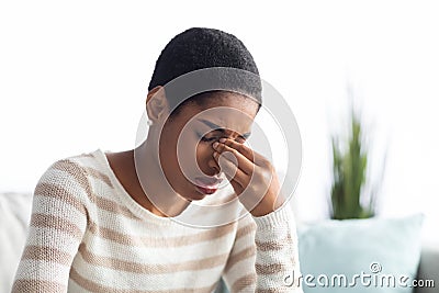 Sinusitis Concept. Sick Young Black Woman Touching Her Nose Bridge At Home Stock Photo